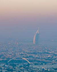 Distant view of burj al arab hotel during sunrise