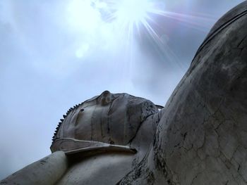 Low angle view of statue against sky on sunny day