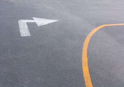 High angle view of arrow sign on road