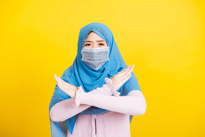 Portrait of teenage girl covering face