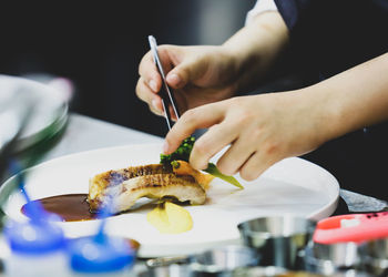 Midsection of person preparing food