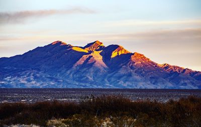 Scenic view of snowcapped mountain against sky during sunset