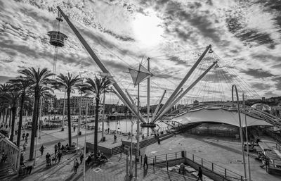 Scenic view of palm trees and bridge against sky