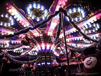 Low angle view of illuminated christmas lights at night