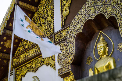 Low angle view of statue against temple building