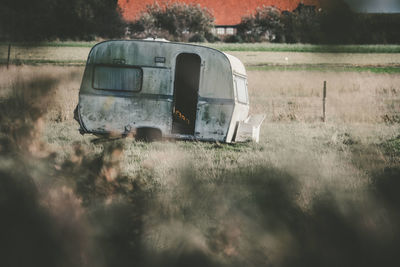 Abandoned car on field