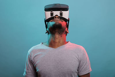 Man looking up while wearing virtual reality headset