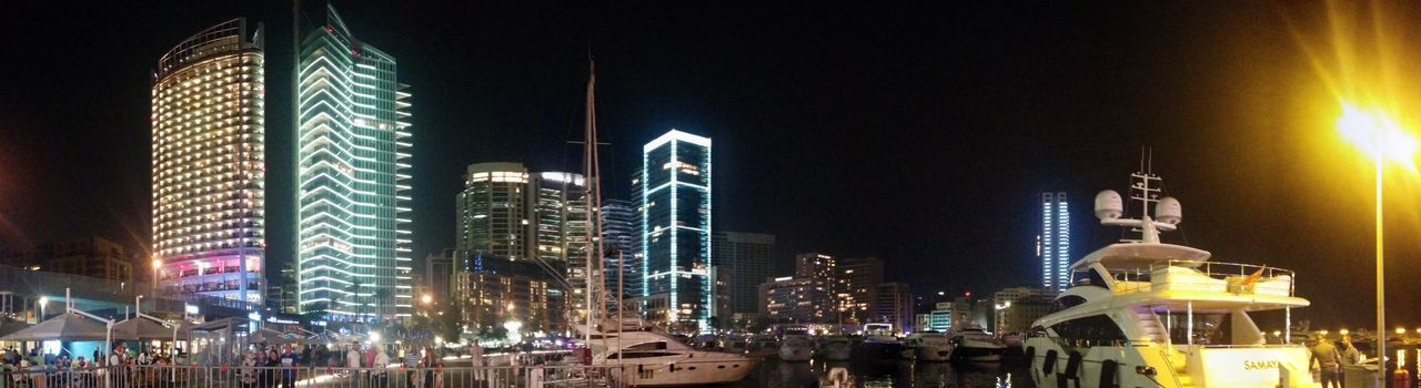 LOW ANGLE VIEW OF ILLUMINATED SKYSCRAPERS AGAINST SKY