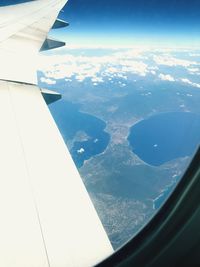 Aerial view of airplane wing over landscape