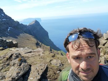 Portrait of man in mountains against sky