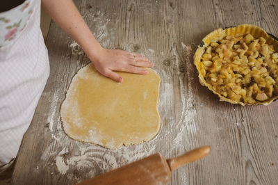 High angle view of woman preparing apple pie