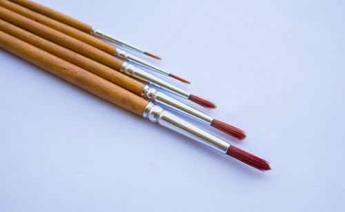 High angle view of pencils on table against white background