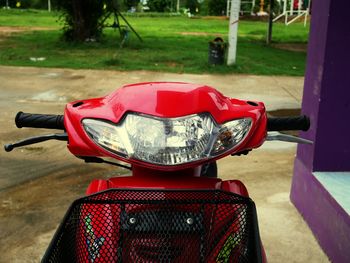 Red motor scooter parked outdoors