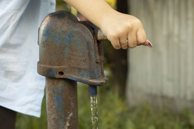 Close-up of human hand holding metal