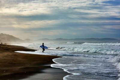 Man on beach against sky