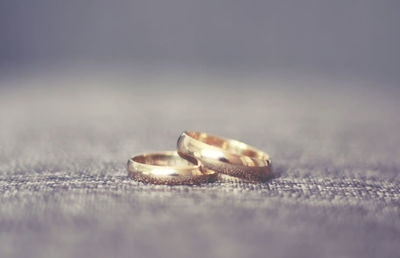 Close-up of wedding rings on floor