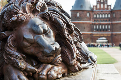 Close-up of statue against building in city