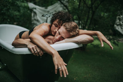 High angle view of friends lying on plant