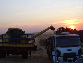 Scenic view of agricultural field against sky during sunset