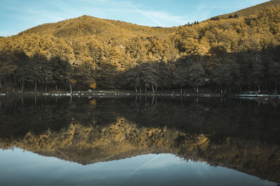 Scenic view of lake and mountains against sky