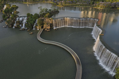 High angle view of bicycle by river against trees