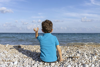 Feeling the ocean breeze and the excitement of throwing stones into the water
