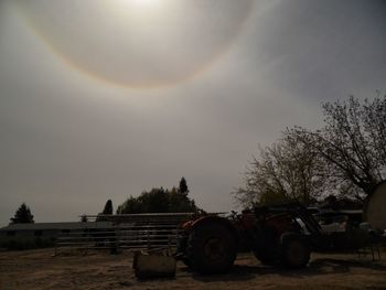 Vehicles parked against the sky on sunny day