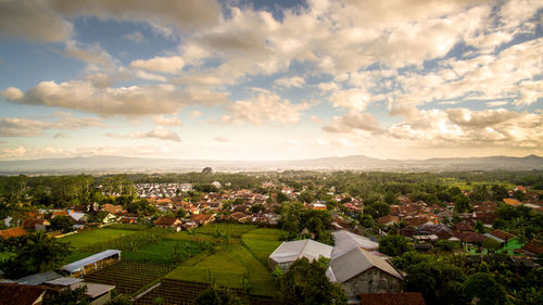 High angle view of houses in town against sky