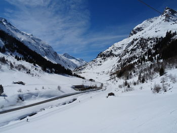 Scenic view of snow covered mountains against sky