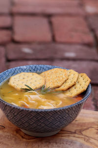 High angle view of soup with crackers on wooden table