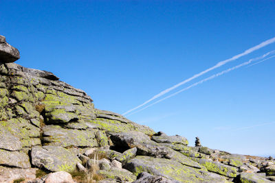 Low angle view of vapor trail against clear blue sky