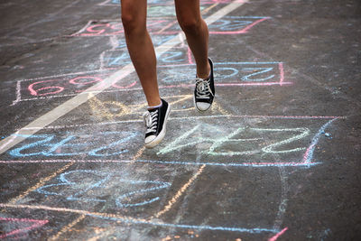 Low section of teenage girl playing outdoors