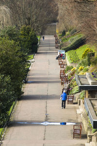 Rear view of people walking on footpath