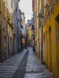 Narrow alley amidst buildings in city