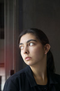 Portrait of a young woman looking away