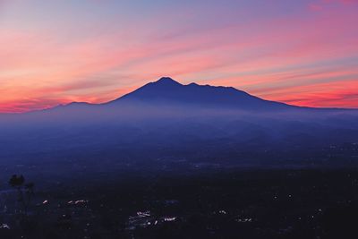 Scenic view of silhouette mountains against romantic sky during sunset