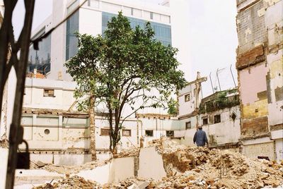 Rear view of people in front of buildings