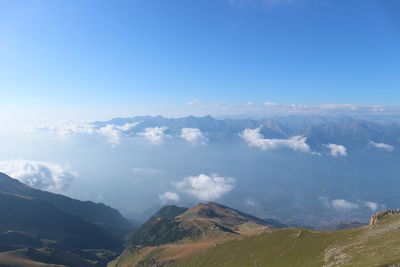 Scenic view of mountains against blue sky