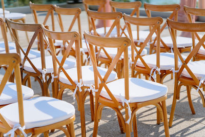 Empty chairs and tables at sidewalk cafe