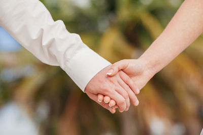 Close-up of couple holding hands