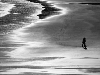 Full length of people walking on beach