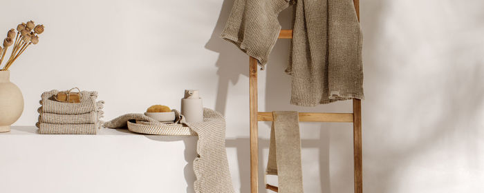 Clothes hanging on table against wall at home