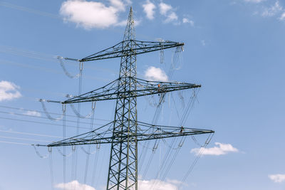 Low angle view of electricity pylon against sky