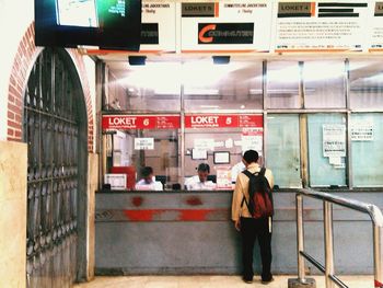 Woman standing at railroad station