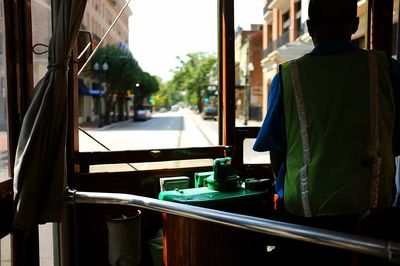 Rear view of person standing in train