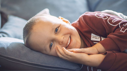 Close-up of boy sleeping on bed at home