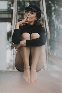 Young woman sitting on floor