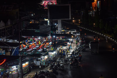 High angle view of street food place with illuminated light at night