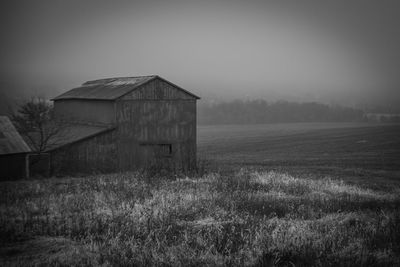 Abandoned house on field against sky