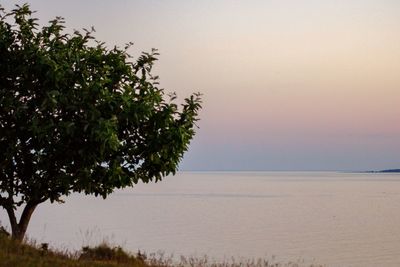 Scenic view of lake against sky at sunset